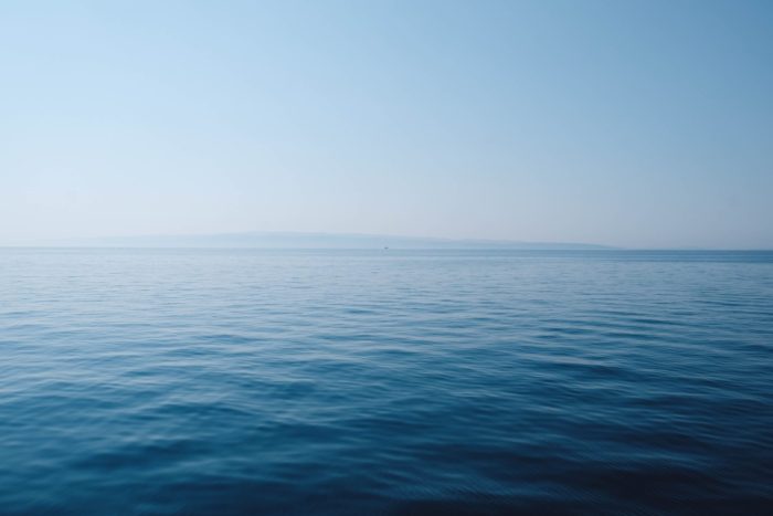 Body Of Water Under Blue And White Sky At Daytime